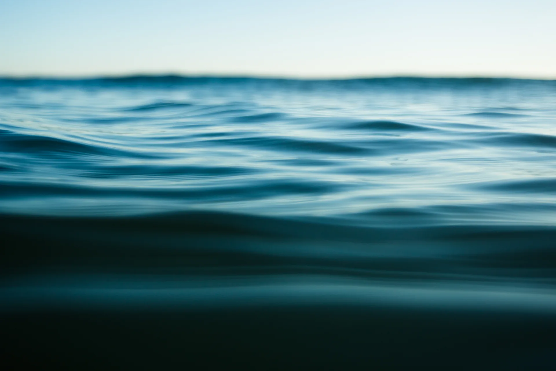 Calm ocean waves at the waterline on a clear day